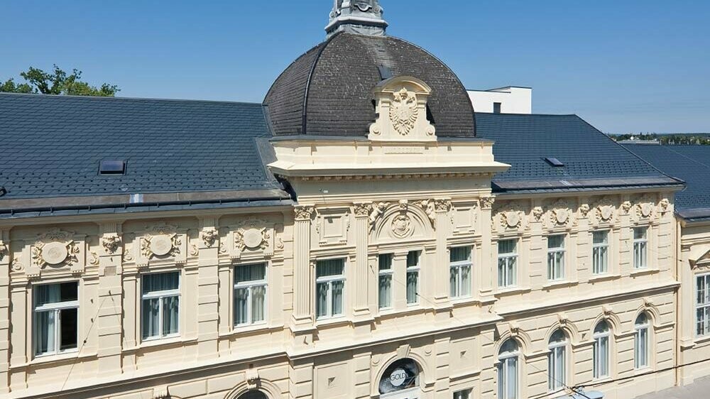 Stadtsäle in St. Pölten mit neuem Dach. Verlegt wurden Dachschindeln von PREFA in der Farbe Anthrazit.